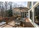 Spacious wooden deck offers outdoor dining with wrought iron table and chairs at 1004 Colworth Way, Raleigh, NC 27614