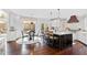 Bright dining area with hardwood floors, a round table, and backyard views at 1004 Colworth Way, Raleigh, NC 27614