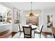Cozy dining area featuring wood floors, a round table, and access to an outdoor living space at 1004 Colworth Way, Raleigh, NC 27614