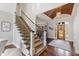 Staircase view of the front entrance highlighting hardwood floors and decorative lighting at 1004 Colworth Way, Raleigh, NC 27614