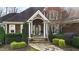 Inviting home exterior with a stone archway, well-manicured landscaping, and a flagstone walkway at 1004 Colworth Way, Raleigh, NC 27614