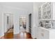 Hallway features a wet bar with custom cabinets, a sink, an espresso machine, and openings to other living areas at 1004 Colworth Way, Raleigh, NC 27614
