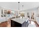 Spacious kitchen featuring granite counters, farmhouse sink, and an island with barstool seating at 1004 Colworth Way, Raleigh, NC 27614