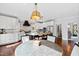 Gourmet kitchen featuring custom white cabinets, a large island, stainless appliances, and hardwood flooring at 1004 Colworth Way, Raleigh, NC 27614