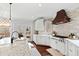 Modern kitchen boasts stainless steel appliances, custom cabinets, and a center island with a sink at 1004 Colworth Way, Raleigh, NC 27614