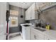 Well-equipped laundry room with a utility sink, washer and dryer, gray walls, and storage cabinets at 1004 Colworth Way, Raleigh, NC 27614