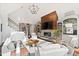 Bright living room featuring vaulted ceiling, stone fireplace, built-in shelving, and neutral-toned furnishings at 1004 Colworth Way, Raleigh, NC 27614