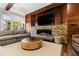 Comfortable living room with fireplace and a large TV and round wood coffee table at 1004 Colworth Way, Raleigh, NC 27614