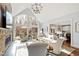 Bright living room with large windows, comfortable seating, and a stone fireplace at 1004 Colworth Way, Raleigh, NC 27614