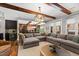 Open concept living room showcasing exposed beams and seamless flow into the game room at 1004 Colworth Way, Raleigh, NC 27614
