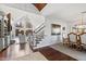 Open living space with hardwood floors, a cozy fireplace, and dining area at 1004 Colworth Way, Raleigh, NC 27614