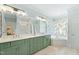 Bright main bathroom featuring dual sinks, a soaking tub, a separate shower, and stylish fixtures at 1004 Colworth Way, Raleigh, NC 27614