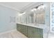 Bathroom showcasing a dual sink vanity, a soaking tub, a separate shower, and modern lighting at 1004 Colworth Way, Raleigh, NC 27614