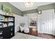 Cozy office space featuring wainscotting, decor lighting and seamless flow into the dining area at 1004 Colworth Way, Raleigh, NC 27614