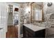Stylish powder room featuring decorative wallpaper, a marble countertop, and an ornate mirror at 1004 Colworth Way, Raleigh, NC 27614