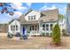 Backyard featuring a patio, grill, lush landscaping, and manicured lawn at 1129 Sequoia Creek Ln, Cary, NC 27519
