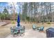 Spacious backyard with a patio, outdoor seating, and a well-maintained lawn at 1129 Sequoia Creek Ln, Cary, NC 27519