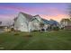 Backyard with an outdoor patio, a grill, a lush green lawn, and beautiful twilight skies at 1129 Sequoia Creek Ln, Cary, NC 27519
