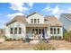 A backyard featuring an outdoor patio, grill, manicured shrubs, and comfortable seating at 1129 Sequoia Creek Ln, Cary, NC 27519