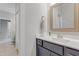 Stylish bathroom featuring a vanity with a sink, decorative mirror and modern finishes at 1129 Sequoia Creek Ln, Cary, NC 27519