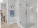 Bathroom featuring a frameless glass shower and closet access at 1129 Sequoia Creek Ln, Cary, NC 27519