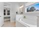Bathroom boasts a marble-surround tub, closet access, and plenty of natural light at 1129 Sequoia Creek Ln, Cary, NC 27519