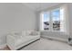 Bright bedroom featuring a comfortable sofa, a large window, and plush carpeting at 1129 Sequoia Creek Ln, Cary, NC 27519