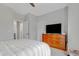 Bedroom featuring a queen bed, dresser, and TV for relaxation and entertainment at 1129 Sequoia Creek Ln, Cary, NC 27519