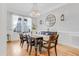 Dining room features a rustic table, elegant chandelier, wainscoting and stylish decor at 1129 Sequoia Creek Ln, Cary, NC 27519