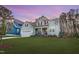 Charming two-story home featuring light blue siding, red shutters, front porch, and an attached two-car garage at 1129 Sequoia Creek Ln, Cary, NC 27519