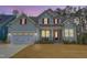 Charming two-story home featuring light blue siding, red shutters, front porch, and an attached two-car garage at 1129 Sequoia Creek Ln, Cary, NC 27519