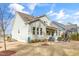 Beautiful home with a well-manicured lawn, a covered patio, and lush landscaping at 1129 Sequoia Creek Ln, Cary, NC 27519