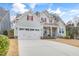 Charming two-story home with a well-kept lawn, attached garage, and inviting entryway at 1129 Sequoia Creek Ln, Cary, NC 27519