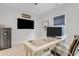 Well-lit home office with a large desk, multiple monitors, and a secure safe at 1129 Sequoia Creek Ln, Cary, NC 27519