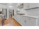 Modern kitchen featuring white cabinets, stainless steel appliances, and a stylish backsplash at 1129 Sequoia Creek Ln, Cary, NC 27519