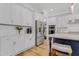 Bright kitchen featuring stainless steel appliances, white cabinetry, and a contrasting blue island at 1129 Sequoia Creek Ln, Cary, NC 27519