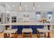 An airy kitchen with a large island, pendant lighting, and seating for casual dining at 1129 Sequoia Creek Ln, Cary, NC 27519