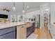 Bright and open kitchen with an island, stainless appliances, and convenient access to a walk-in pantry at 1129 Sequoia Creek Ln, Cary, NC 27519