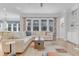 Bright living room features a large sofa, hardwood floors and stylish window treatments at 1129 Sequoia Creek Ln, Cary, NC 27519