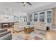 Open-concept living room features hardwood floors, large windows, and cozy seating at 1129 Sequoia Creek Ln, Cary, NC 27519