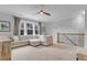 Spacious living room with a large sectional sofa and staircase leading to a second floor at 1129 Sequoia Creek Ln, Cary, NC 27519