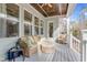 Relaxing screened-in porch with a ceiling fan, comfortable seating, and natural light at 1129 Sequoia Creek Ln, Cary, NC 27519