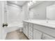 Bathroom with double sink vanity with white cabinets, tub and tile flooring at 120 Breyla Way, Holly Springs, NC 27540