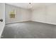 Spacious bedroom with gray carpet, large window and modern lighting fixture at 120 Breyla Way, Holly Springs, NC 27540