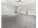 Spacious main bedroom featuring a tray ceiling with fan and neutral decor and gray carpet at 120 Breyla Way, Holly Springs, NC 27540