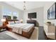 Stylish main bedroom with a large window, contemporary decor and hardwood furniture at 120 Breyla Way, Holly Springs, NC 27540