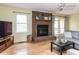 Inviting living room featuring a brick fireplace, hardwood floors, and a cozy seating area with a sofa at 120 Galax Ln, Durham, NC 27703