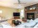 Comfortable living room showcasing a brick fireplace, a large screen TV, and ample seating at 120 Galax Ln, Durham, NC 27703