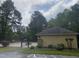 Community pool with a bath house and lounge chairs, surrounded by a tall tree line at 120 Galax Ln, Durham, NC 27703
