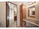 Bathroom vanity with framed mirror, lighting, and a doorway to the shower at 136 Pelham St, Haw River, NC 27258